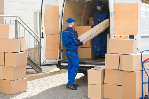 Camden moving team handling furniture safely with protective equipment