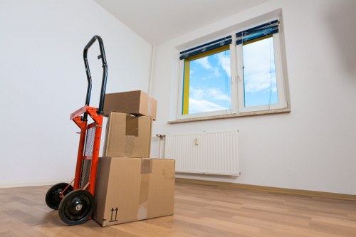Local movers carrying furniture through a Camden street